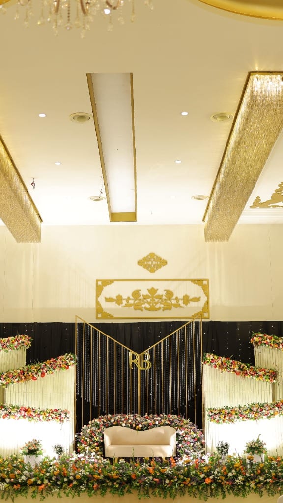 R2R event stage decoration with chandeliers and monogram